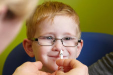 child having nasal spray flu vaccine